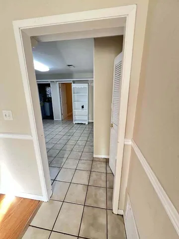 a view of a hallway view with wooden floor and staircase