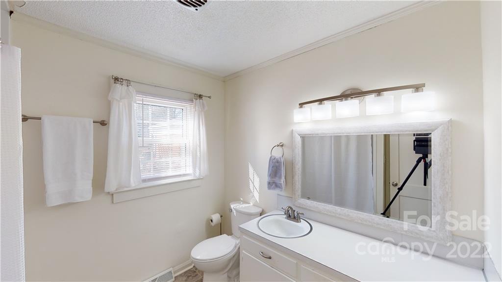 141 Wallaby Road Cherryville, NC 28021 - Photo 26 of 47 a bathroom with a toilet a sink a mirror and a window