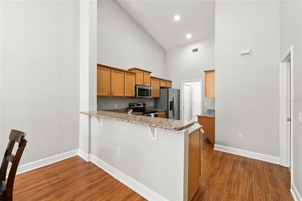 a kitchen with stainless steel appliances a refrigerator and a stove top oven