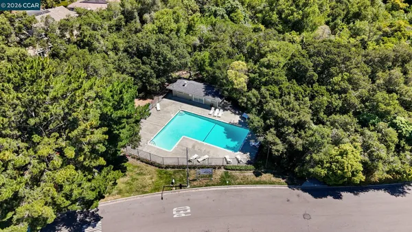 an aerial view of a house with a yard and garden
