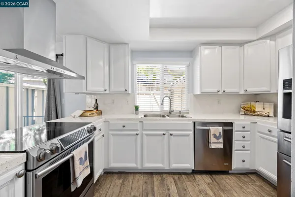 a kitchen with a sink stove and cabinets