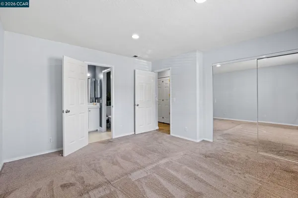 a view of a big room with closet and windows