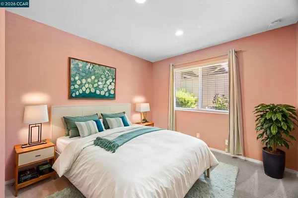 a bedroom with a bed and a potted plant