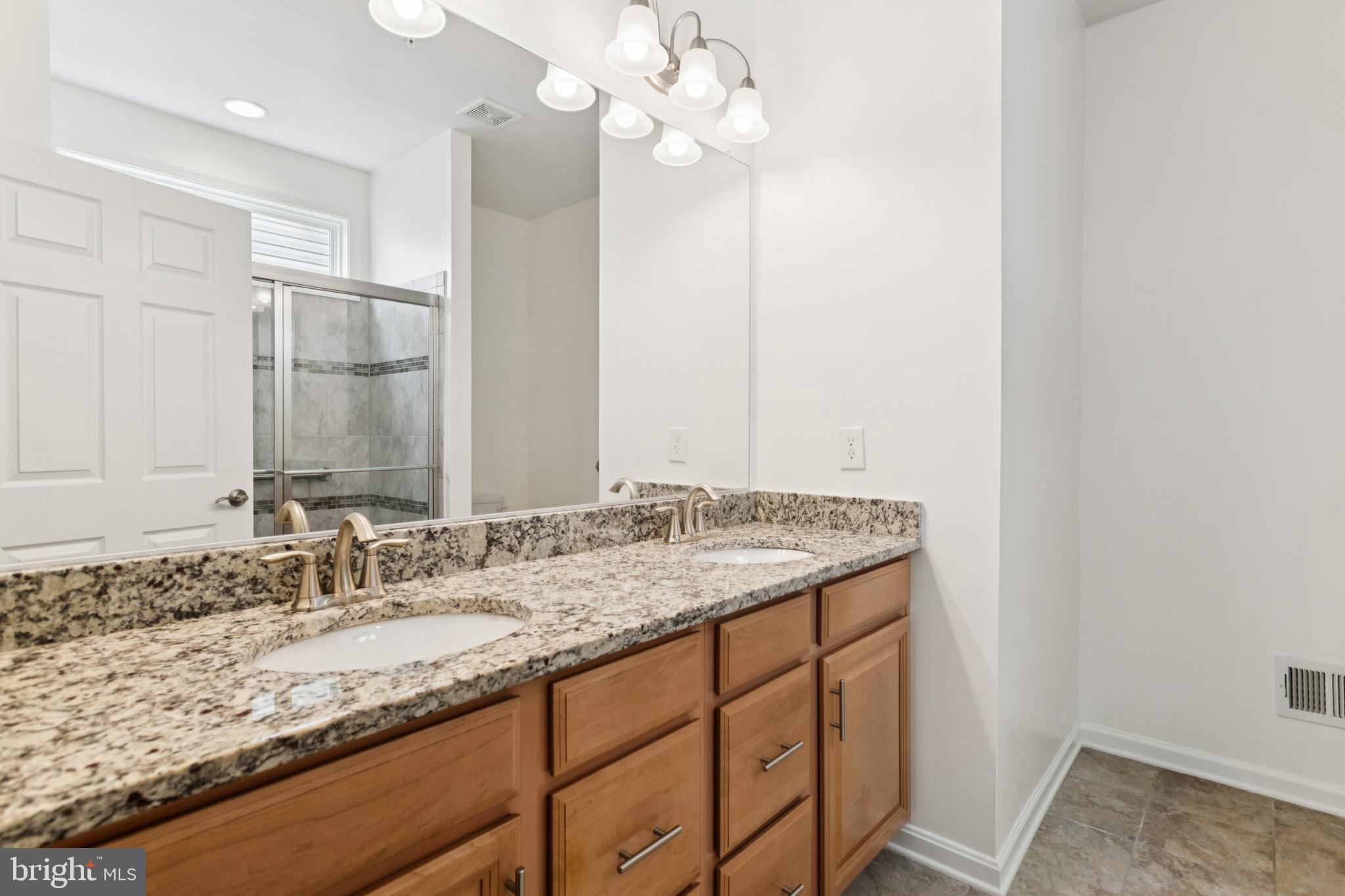 15 Point Bluff Street Fredericksburg, VA 22406 - Photo 17 of 25 a bathroom with a granite countertop sink and a mirror
