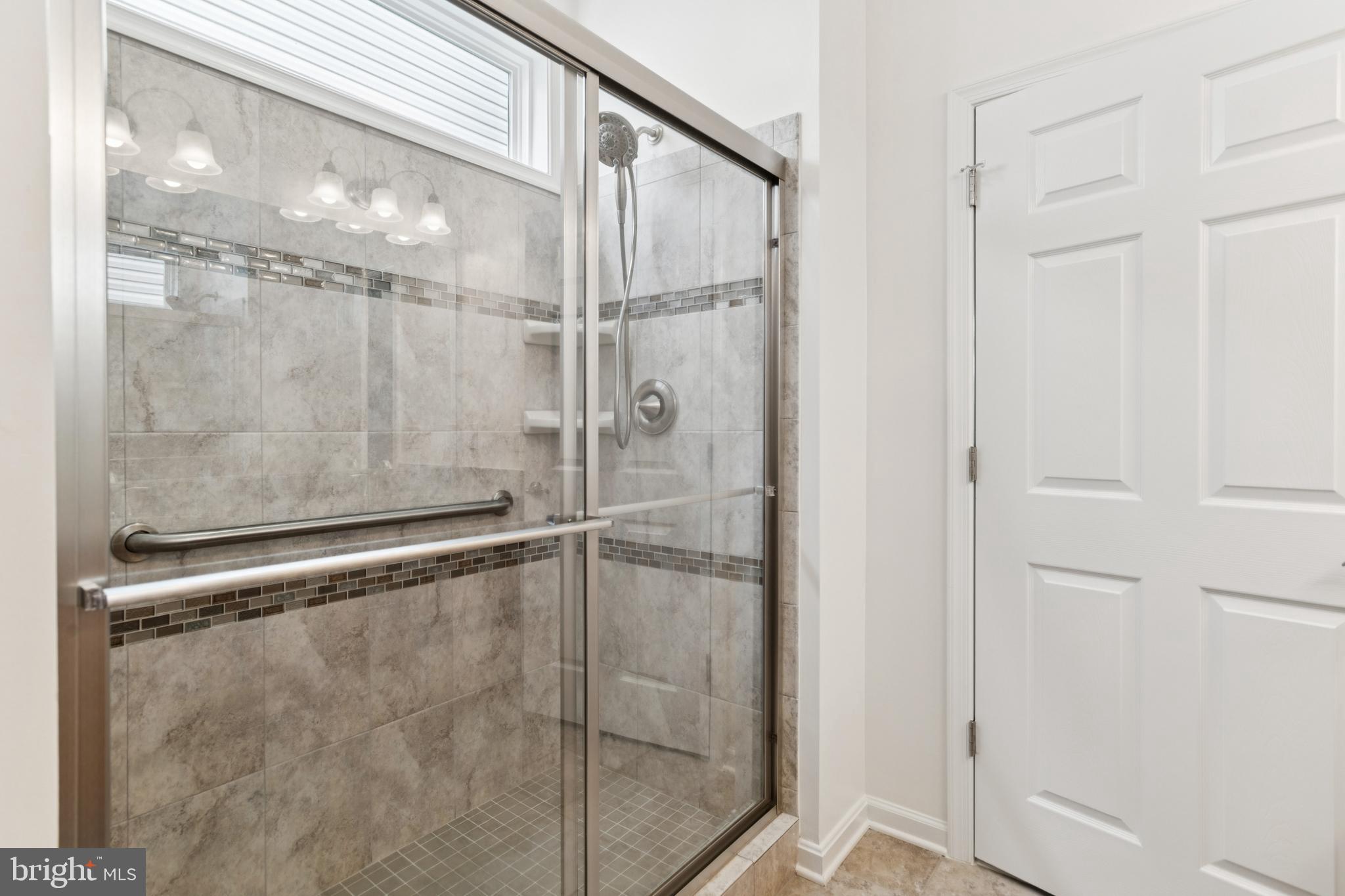15 Point Bluff Street Fredericksburg, VA 22406 - Photo 18 of 25 a bathroom with a glass shower door