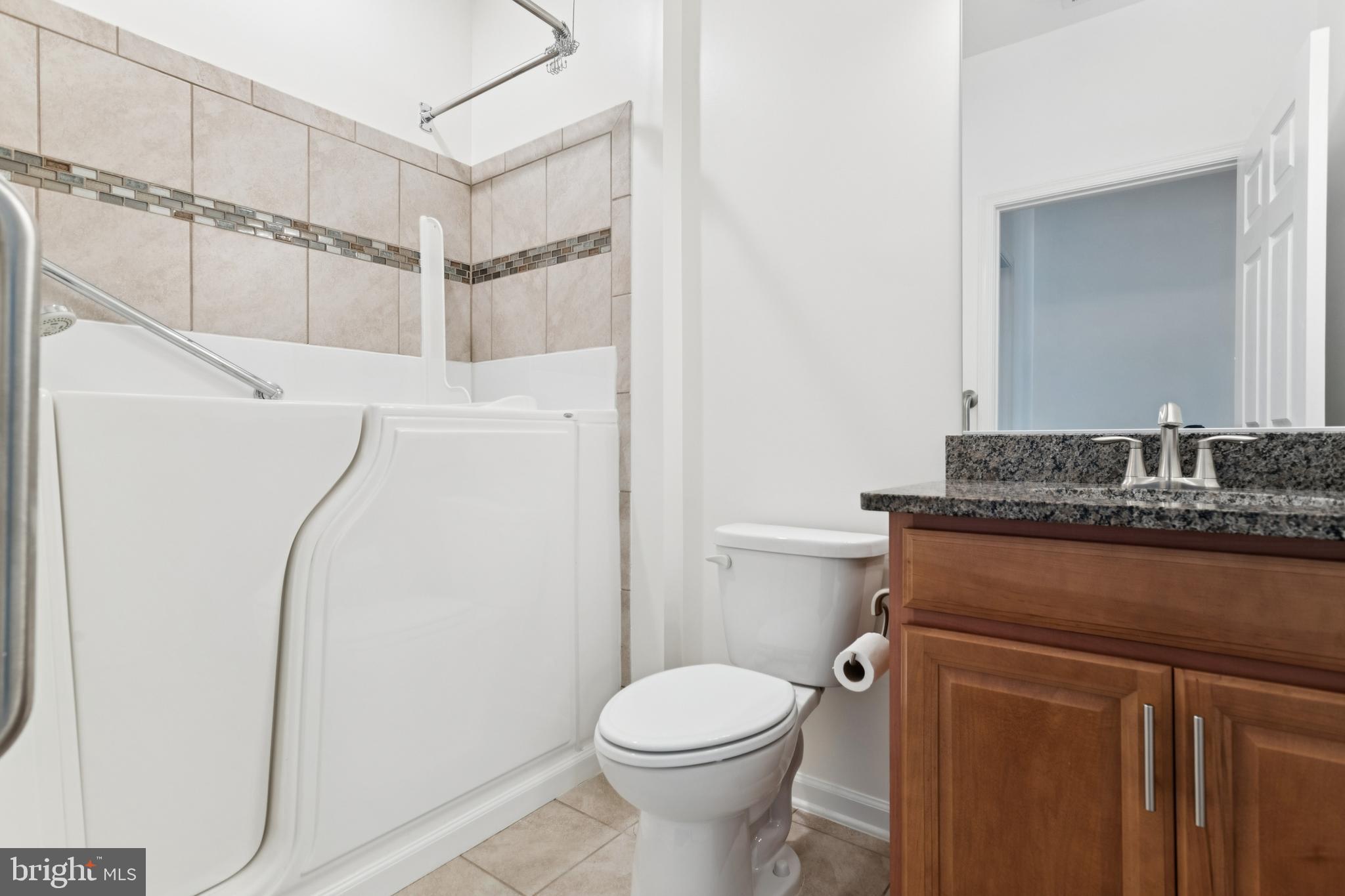 15 Point Bluff Street Fredericksburg, VA 22406 - Photo 20 of 25 a bathroom with a granite countertop toilet sink and shower
