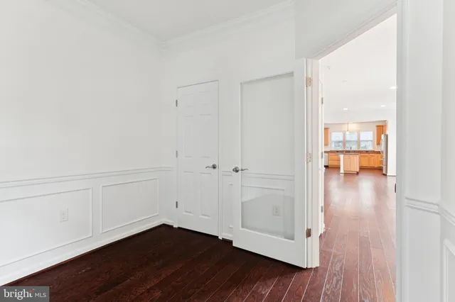 a view of an empty room and wooden floor