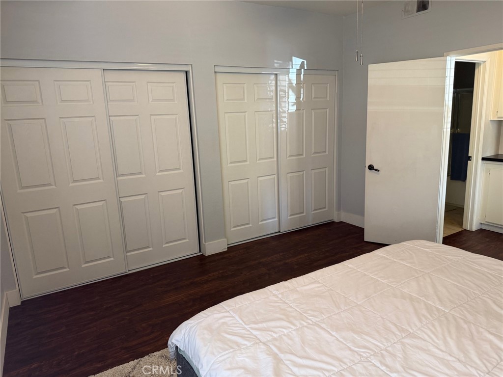 19431 Rue De Valore, Unit 14A Lake Forest, CA 92610 - Photo 14 of 26 a bedroom with a bed and wooden floor