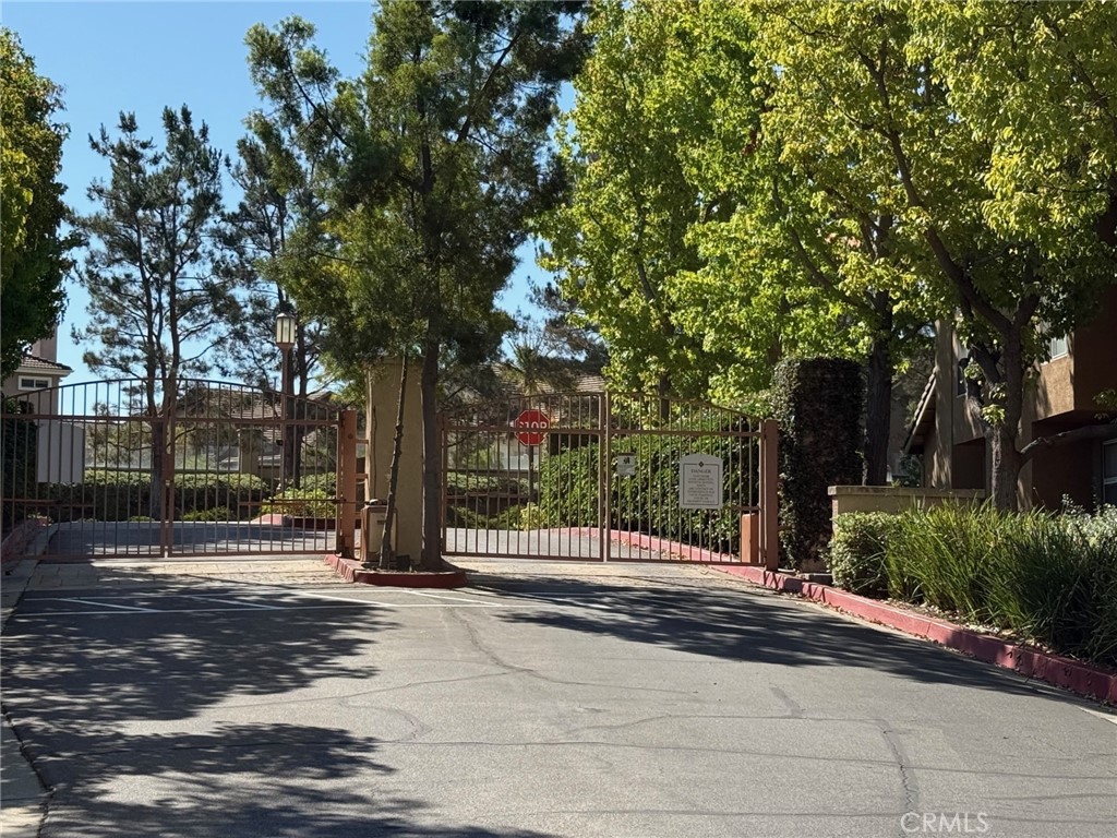 19431 Rue De Valore, Unit 14A Lake Forest, CA 92610 - Photo 25 of 26 a street view with large trees