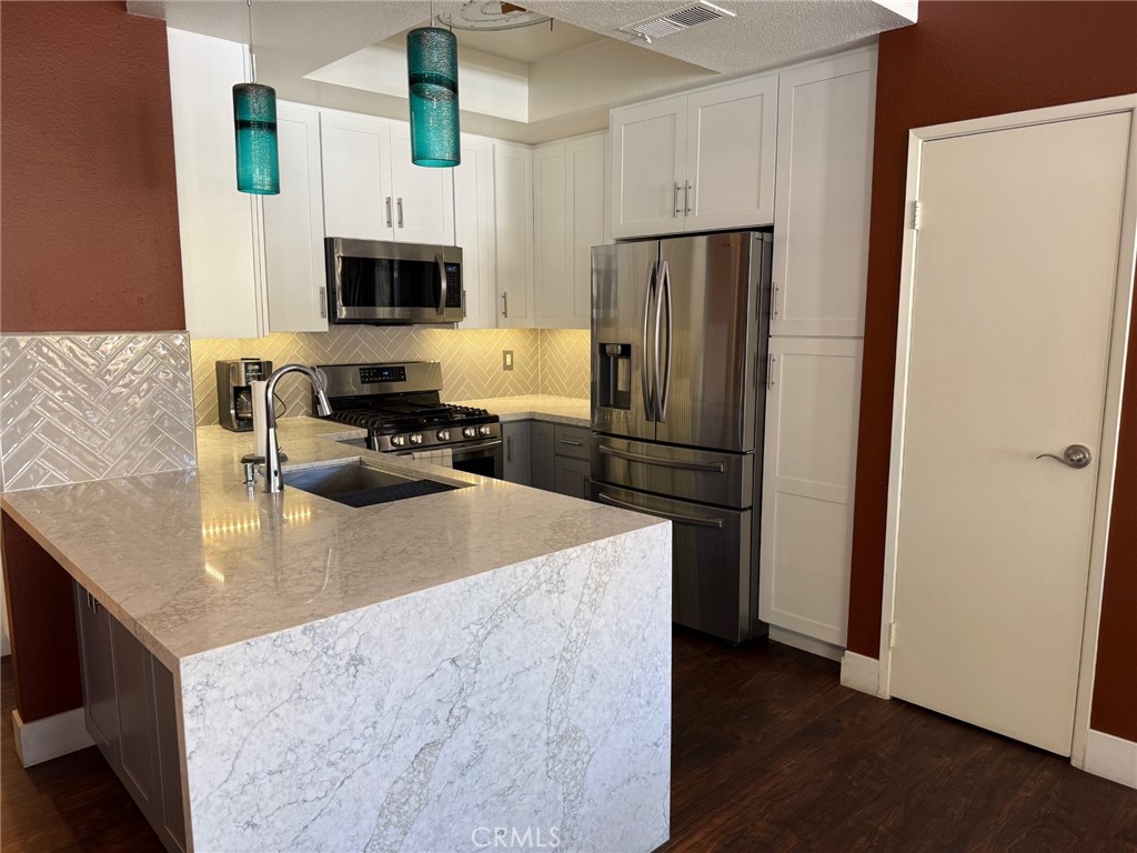 19431 Rue De Valore, Unit 14A Lake Forest, CA 92610 - Photo 3 of 26 Upgraded kitchen, quartz waterfall countertop