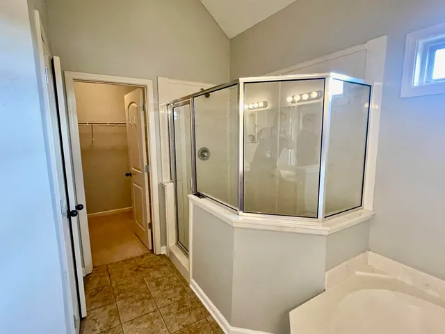 a bathroom with a shower and toilet