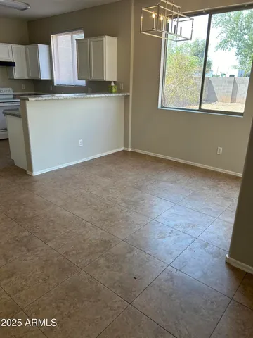 a view of a kitchen with an empty space and window