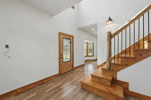 a view of staircase with wooden floor and a rug
