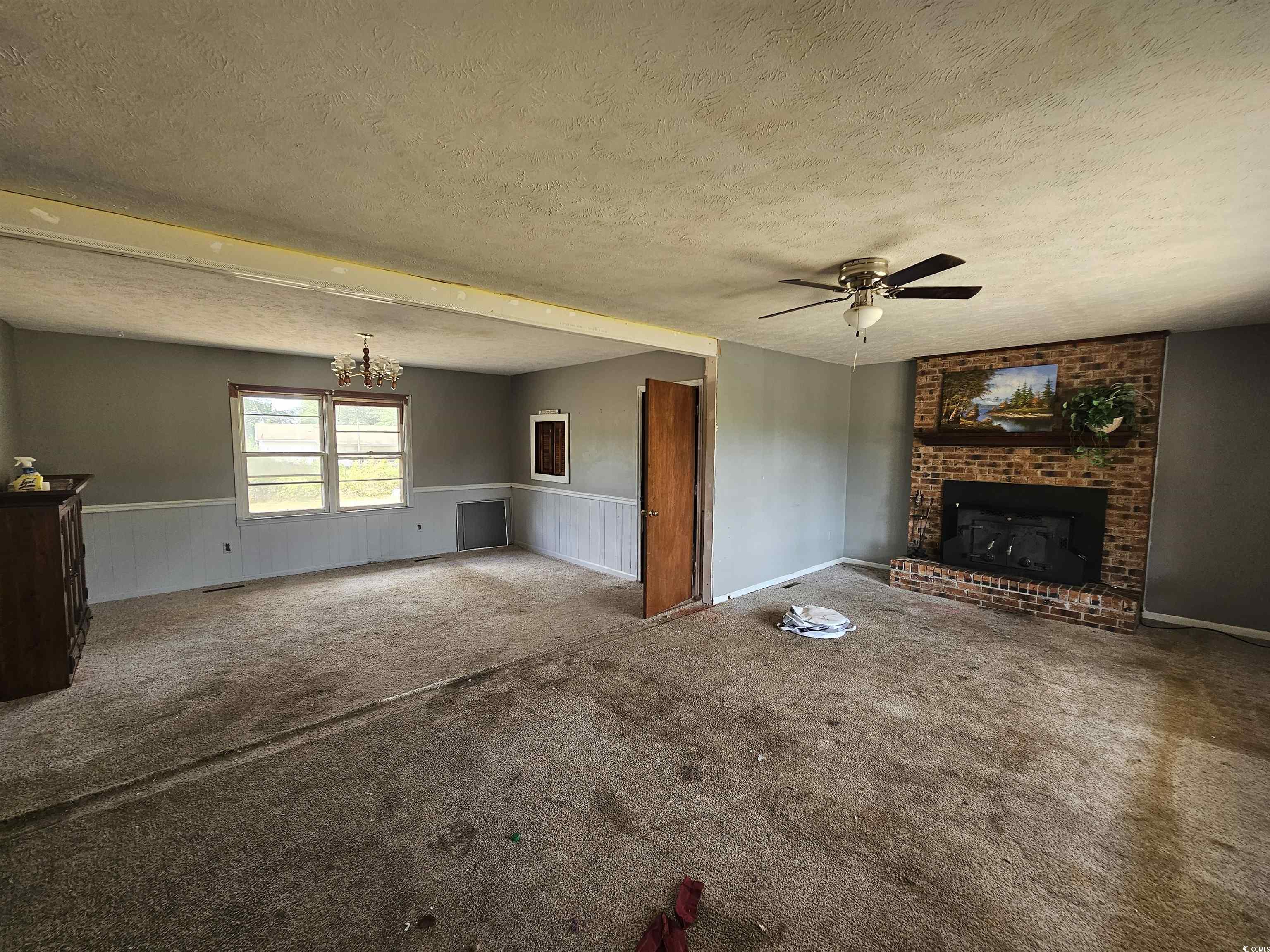 Unfurnished living room with a fireplace, carpet,