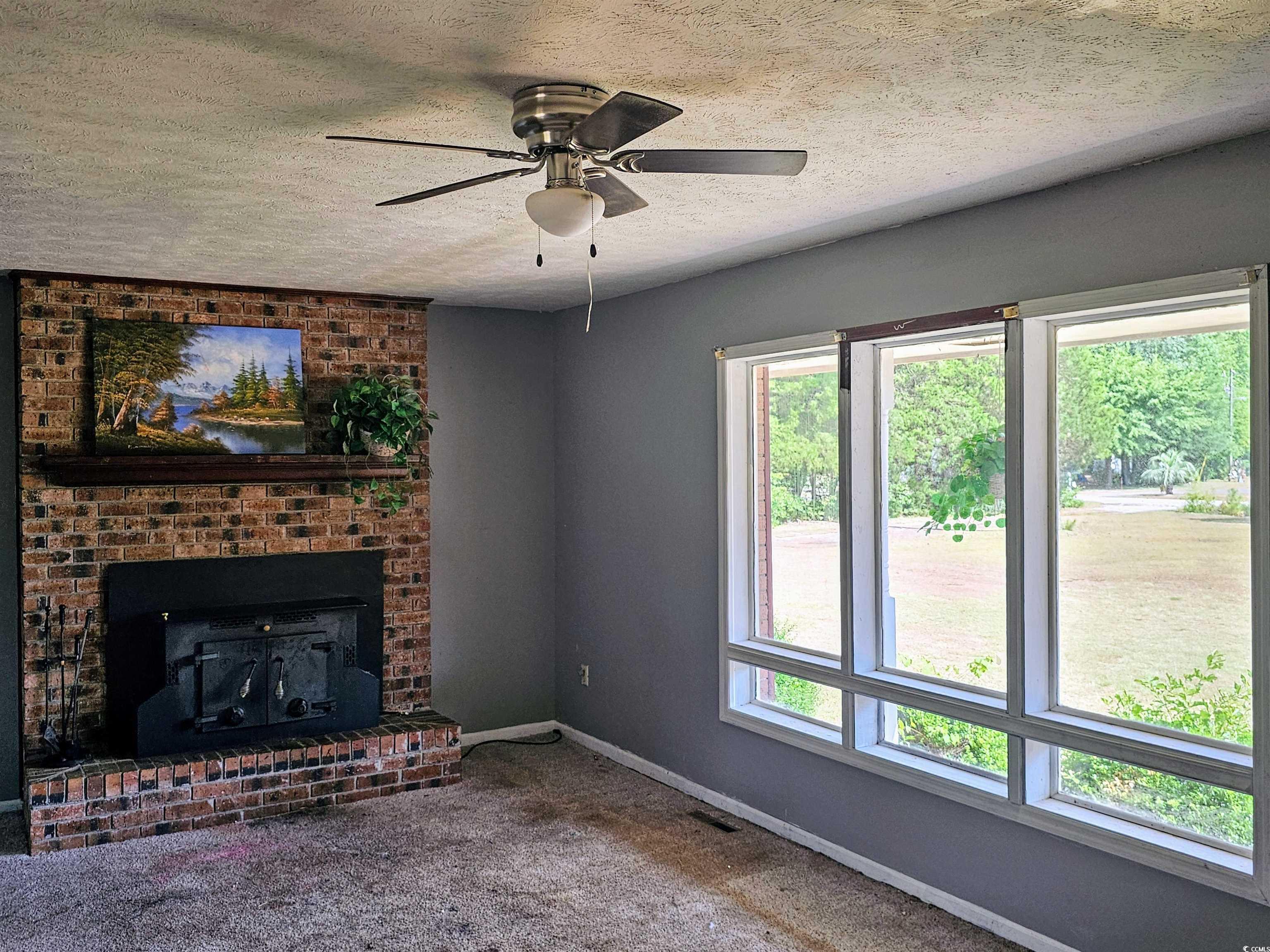 Unfurnished living room with a textured ceiling, c