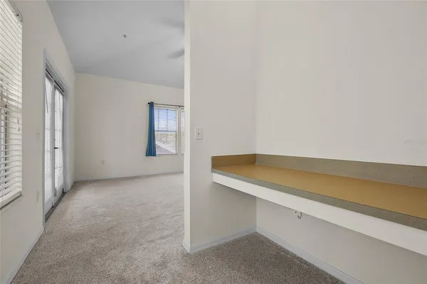 an empty room with windows and closet