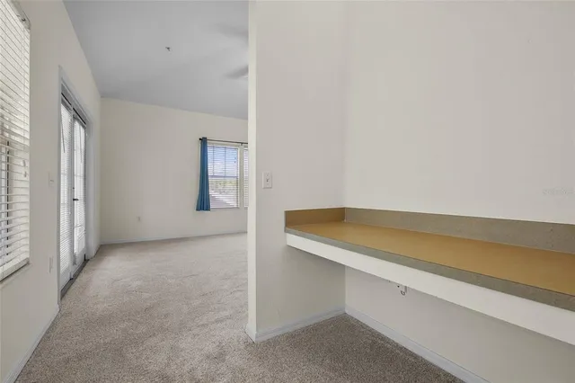 an empty room with windows and closet