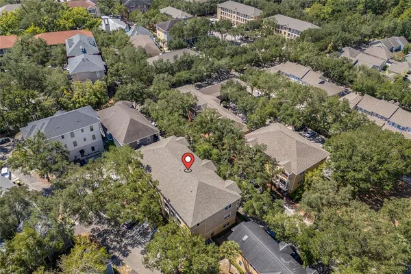 an aerial view of a house with a yard