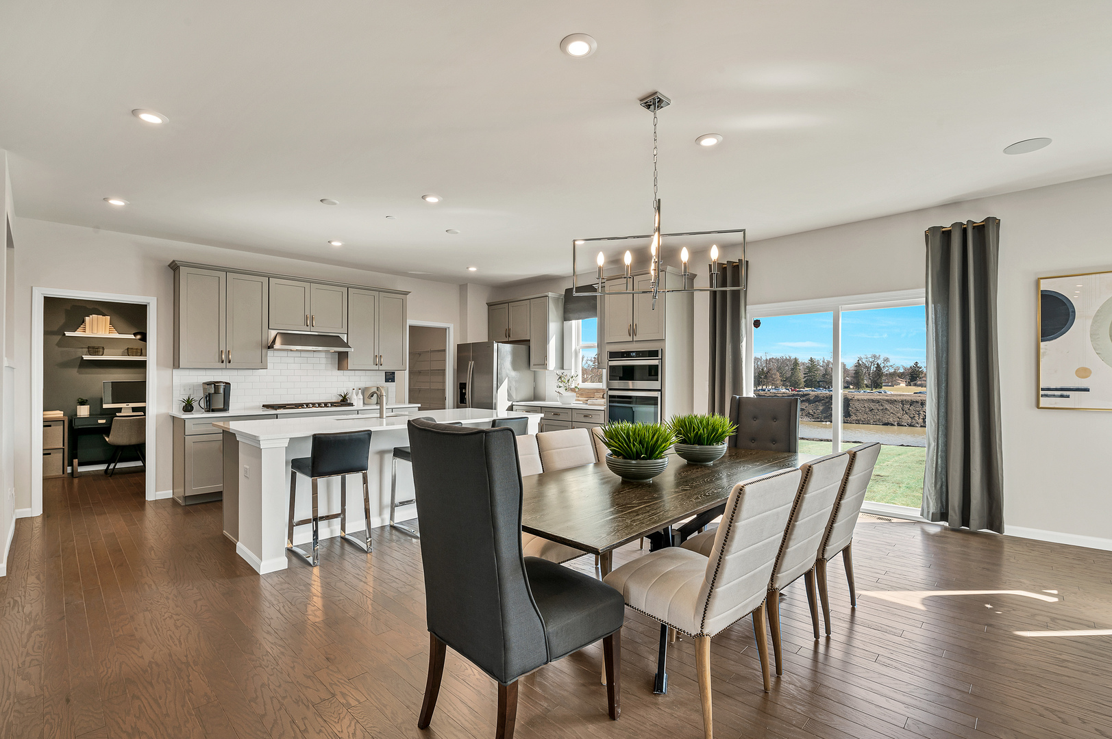 621 North Sullivan Street Addison, IL 60101 - Photo 9 of 22 a view of a dining room and livingroom with furniture wooden floor a chandelier