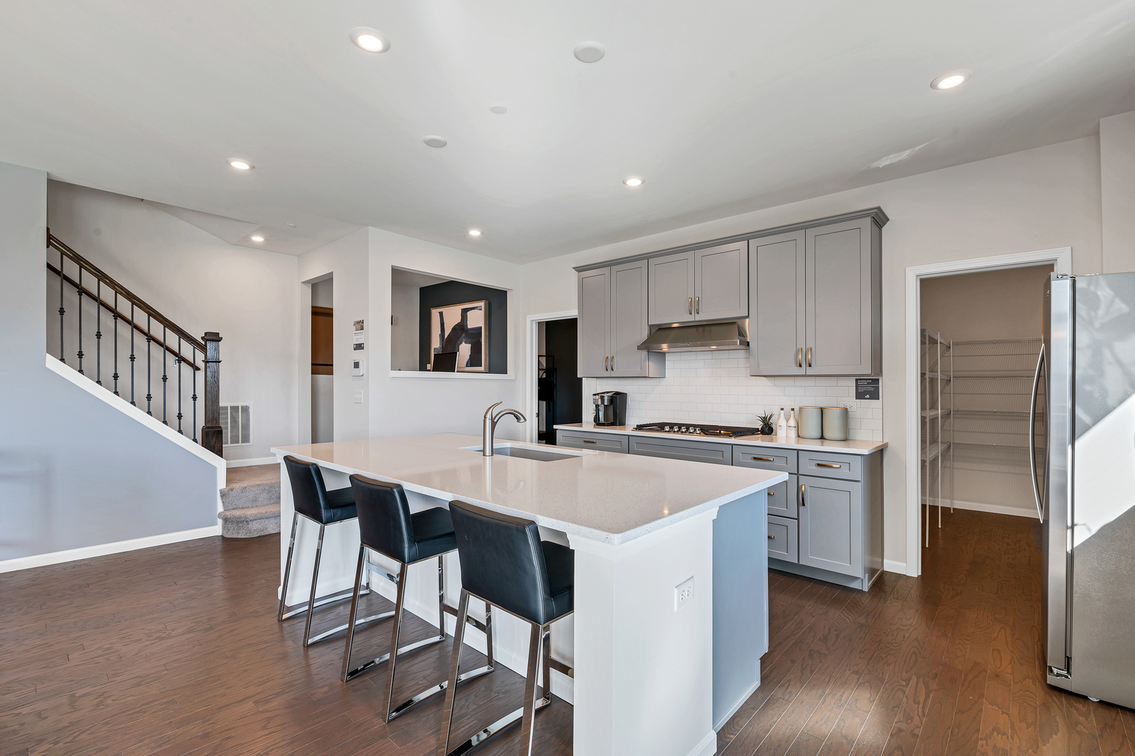 621 North Sullivan Street Addison, IL 60101 - Photo 10 of 22 a kitchen with refrigerator a stove a sink and a island