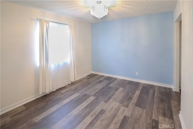 an empty room with wooden floor and closet