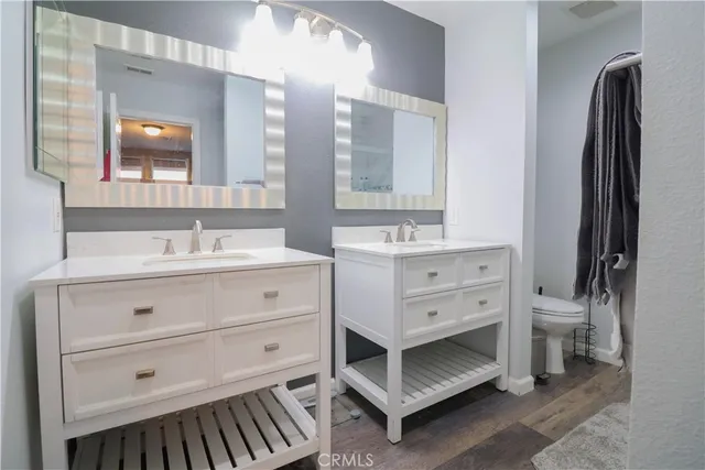 a white toilet sitting next to a sink