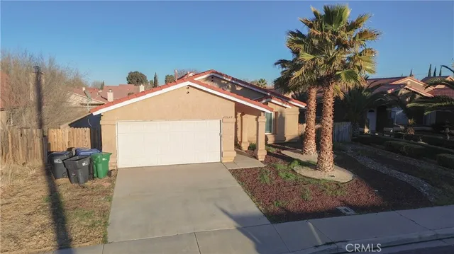a front view of a house with a yard garage and outdoor seating