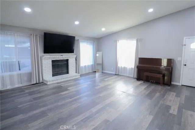 a living room with furniture fireplace and flat screen tv