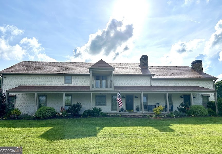 2838 Skitts Mountain Road Cleveland, GA 30528 - Photo 1 of 41 a front view of a house with a garden and plants
