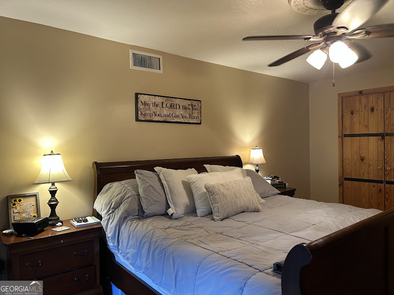 2838 Skitts Mountain Road Cleveland, GA 30528 - Photo 11 of 41 a bedroom with a bed and a lamp