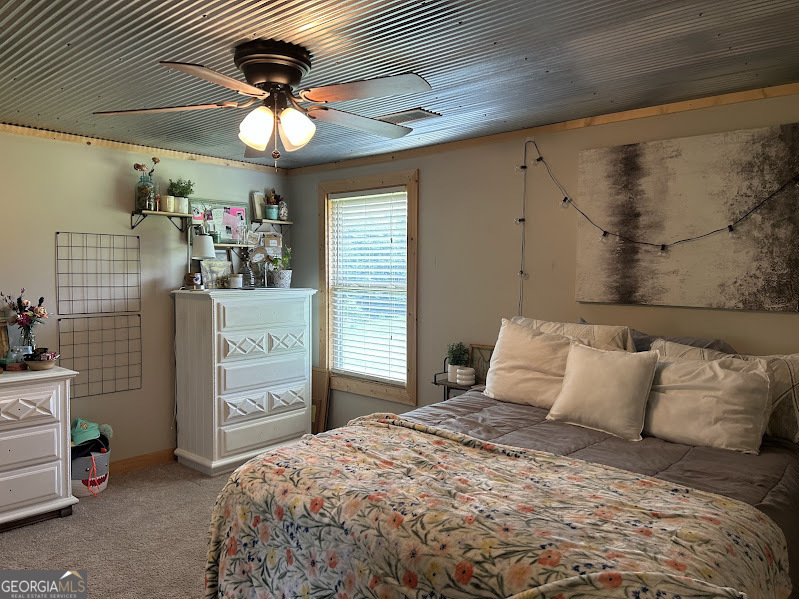 2838 Skitts Mountain Road Cleveland, GA 30528 - Photo 17 of 41 a bedroom with a bed and a chandelier