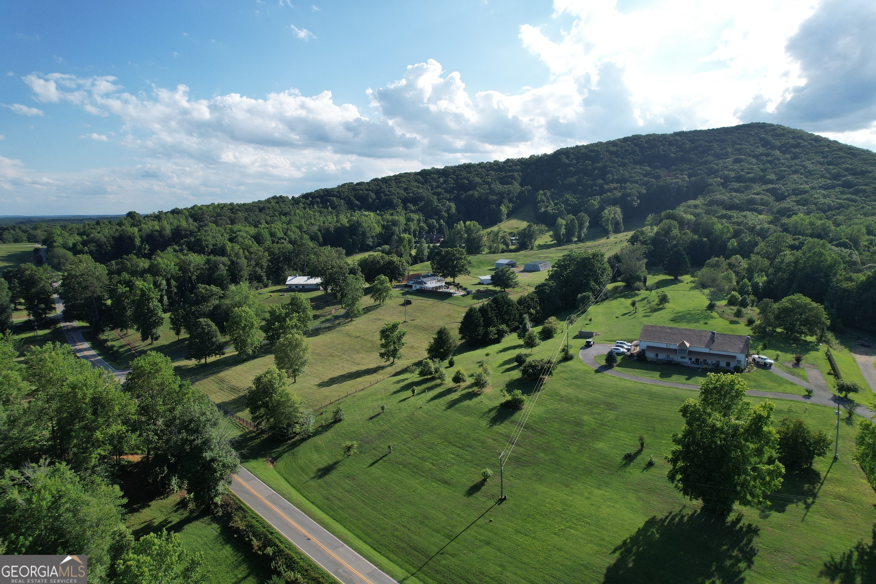 2838 Skitts Mountain Road Cleveland, GA 30528 - Photo 36 of 41 an aerial view of green landscape with trees houses and mountain view