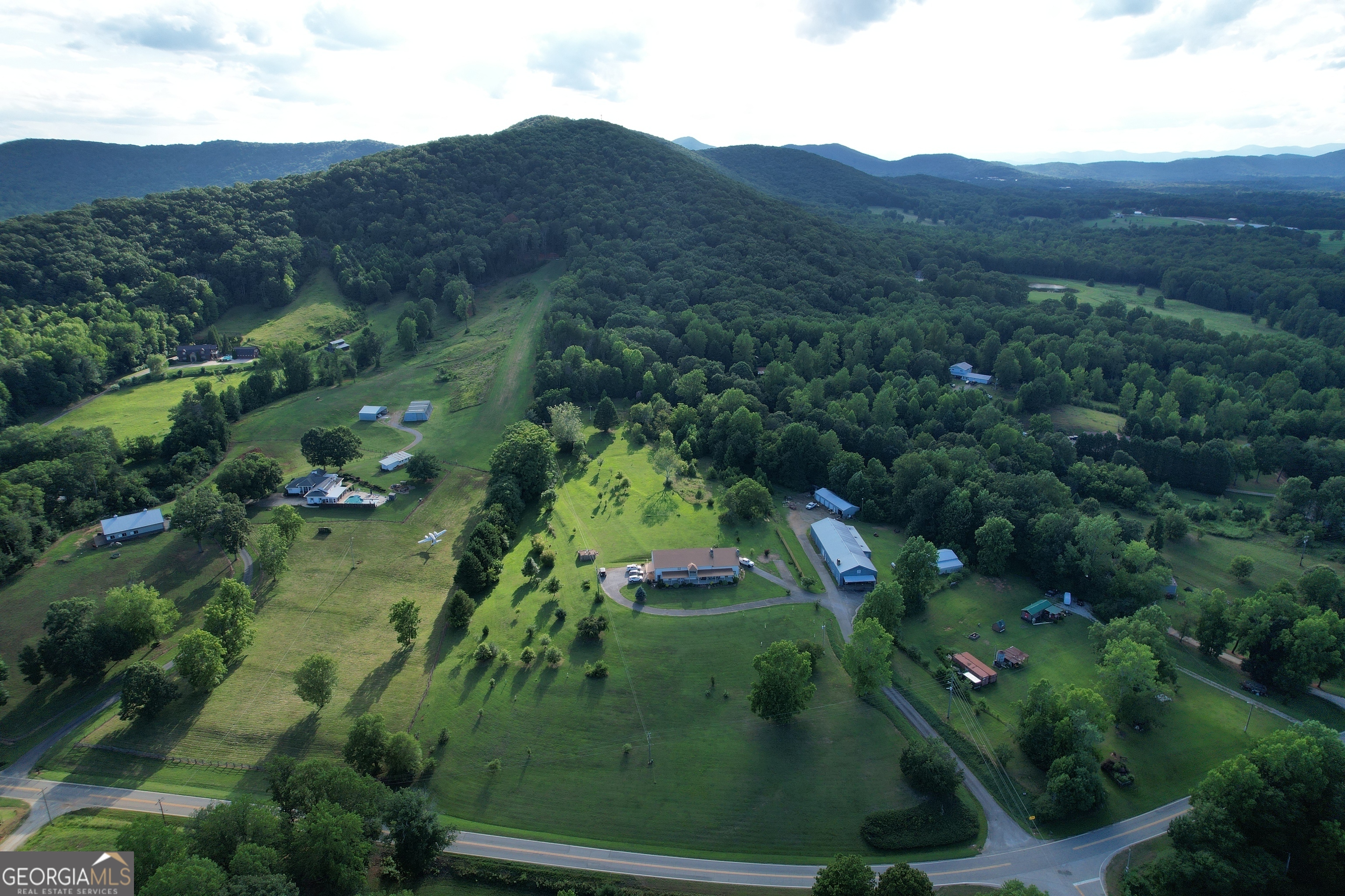 2838 Skitts Mountain Road Cleveland, GA 30528 - Photo 38 of 41 an aerial view of green landscape with trees houses and mountain view