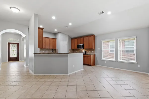 a kitchen with stainless steel appliances granite countertop a refrigerator sink and cabinets