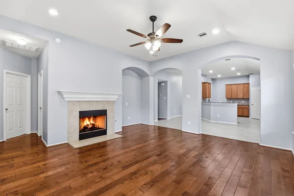 a view of empty room with wooden floor and fireplace