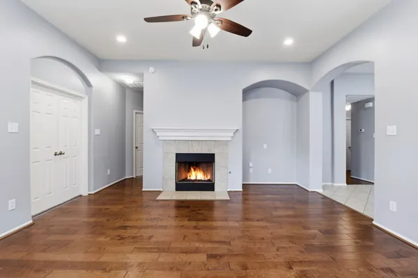 a view of an empty room with a fireplace and a window