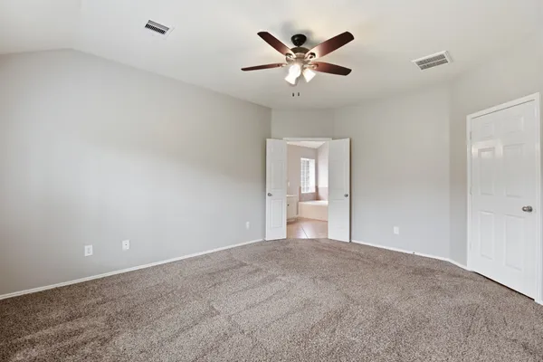 a view of a big room with a chandelier fan