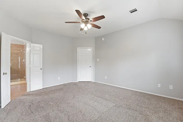 a view of an empty room with a ceiling fan