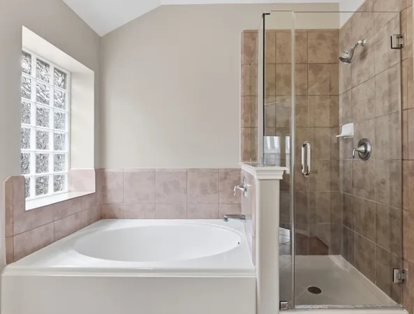 a bathroom with a bathtub and a shower