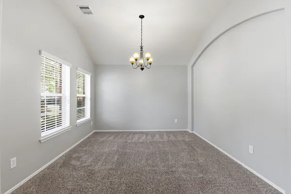 a view of a chandelier in big room and chandelier fan in big room
