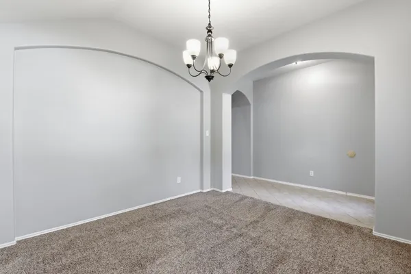 a view of a chandelier in big room and chandelier
