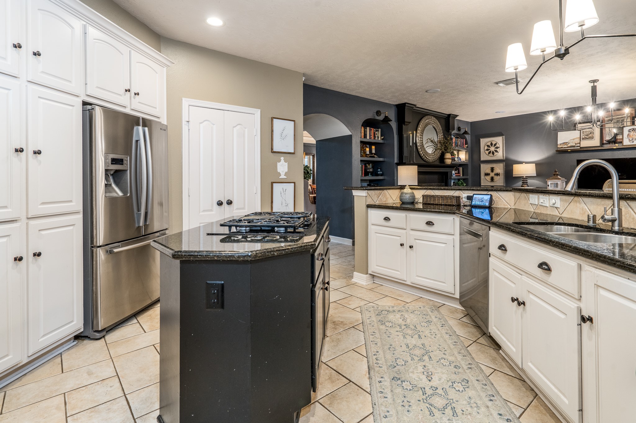 10411 Harnwell Crossing Drive Spring, TX 77379 - Photo 13 of 50 a kitchen with stainless steel appliances granite countertop a refrigerator a stove and a sink