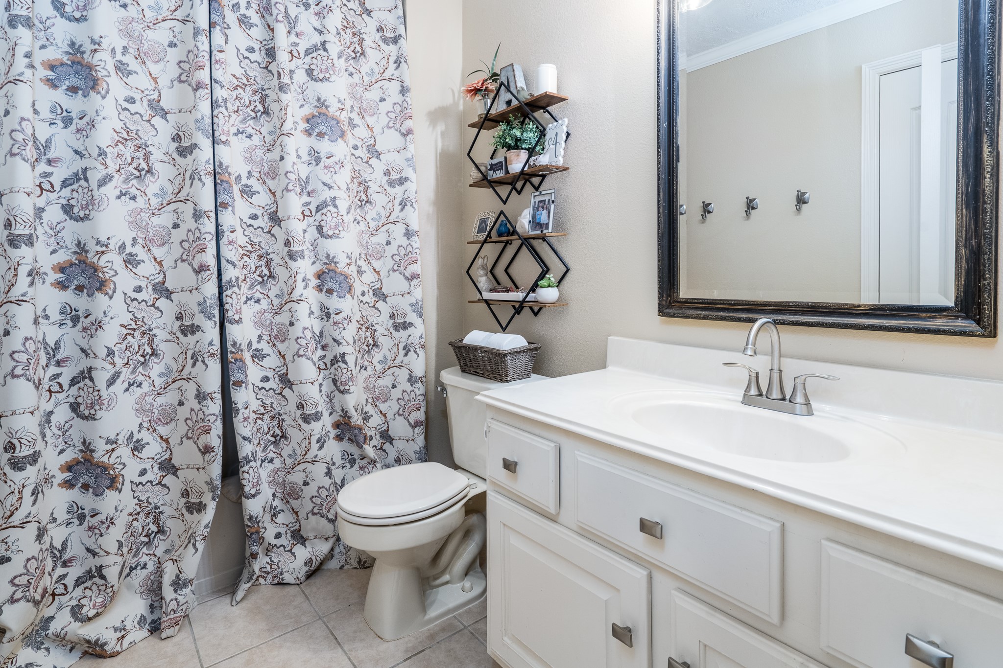 10411 Harnwell Crossing Drive Spring, TX 77379 - Photo 36 of 50 a bathroom with a granite countertop sink a toilet and a mirror