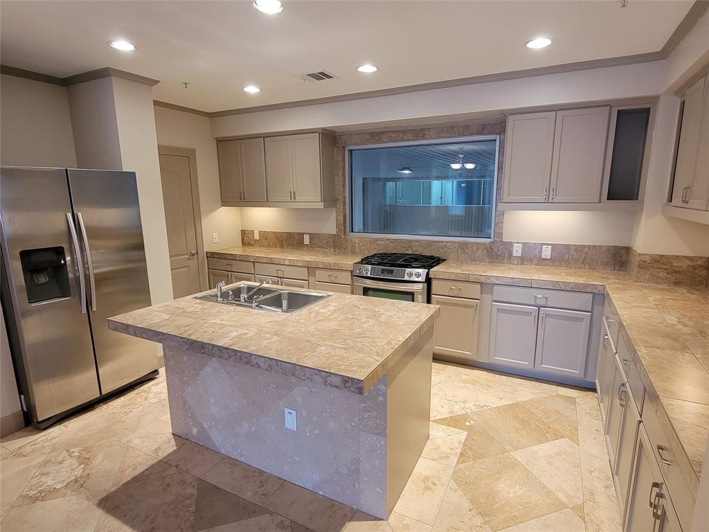 a kitchen with kitchen island a counter top space appliances and cabinets