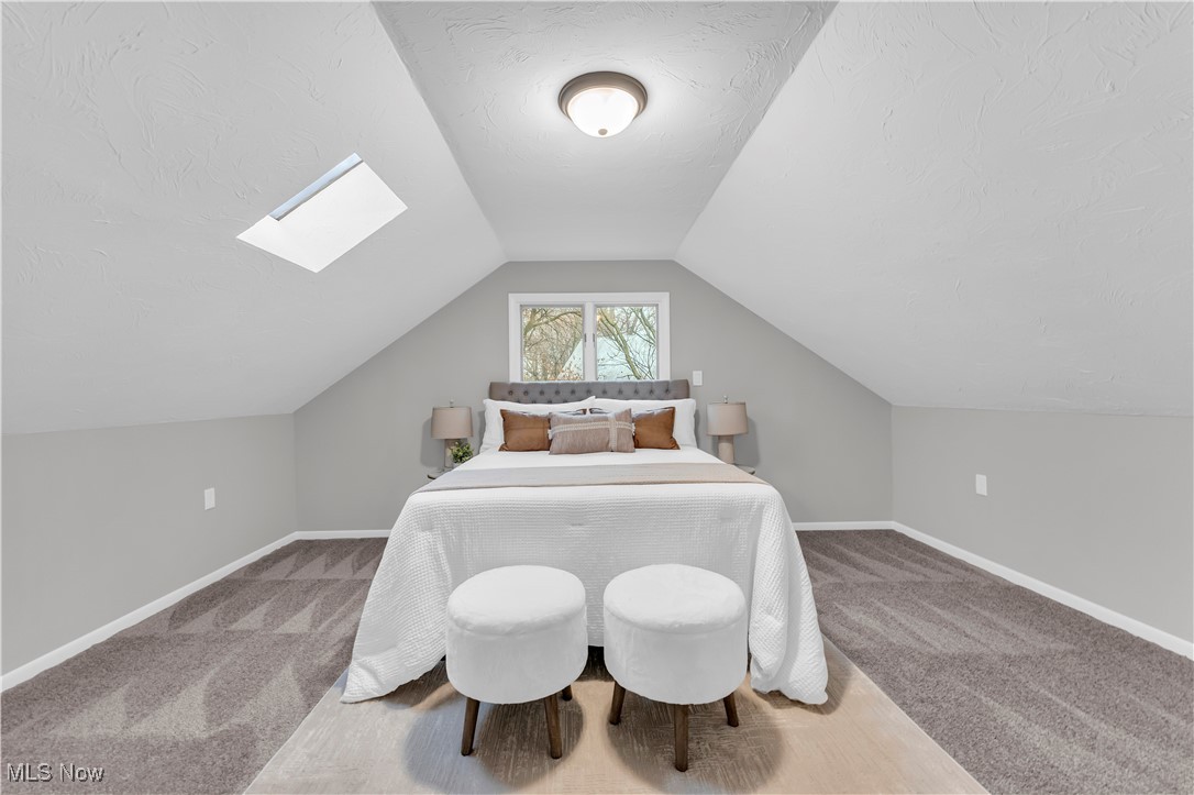 6920 Joppa Road Vermilion, OH 44089 - Photo 25 of 38 Carpeted bedroom with vaulted ceiling with skylight