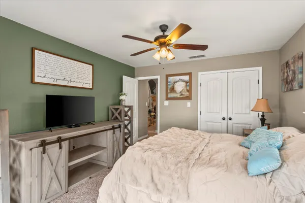 a bedroom with a bed and a flat screen tv