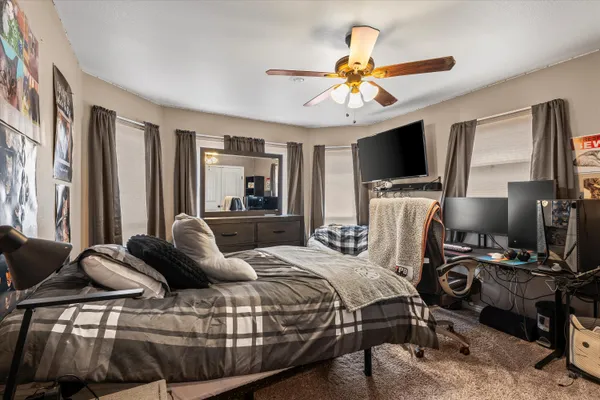 a bedroom with a bed and a flat screen tv
