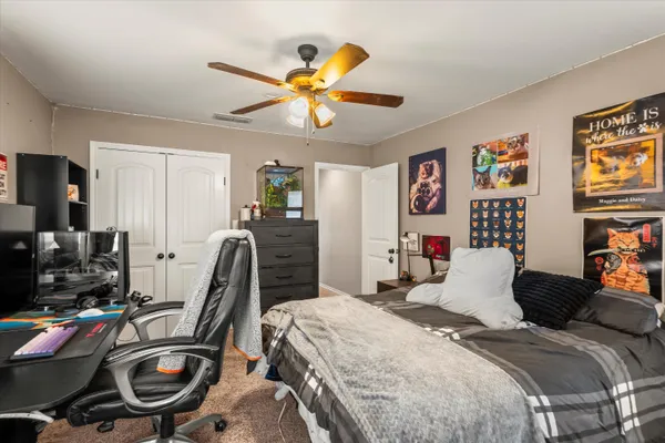 a bedroom with a bed and a chandelier