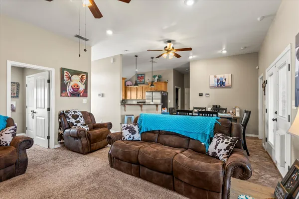a living room with furniture and a chandelier