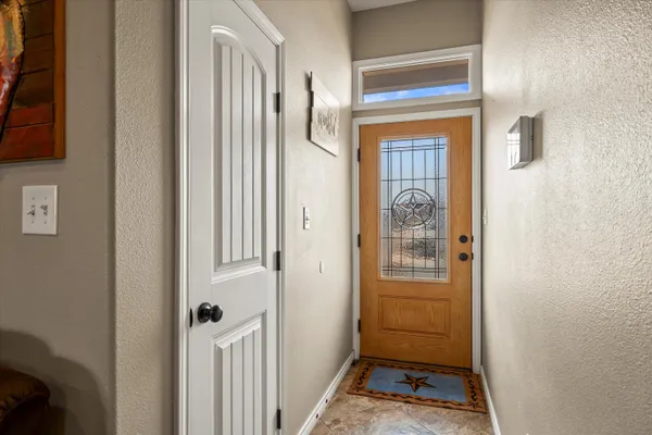 a view of a hallway with a door and couch